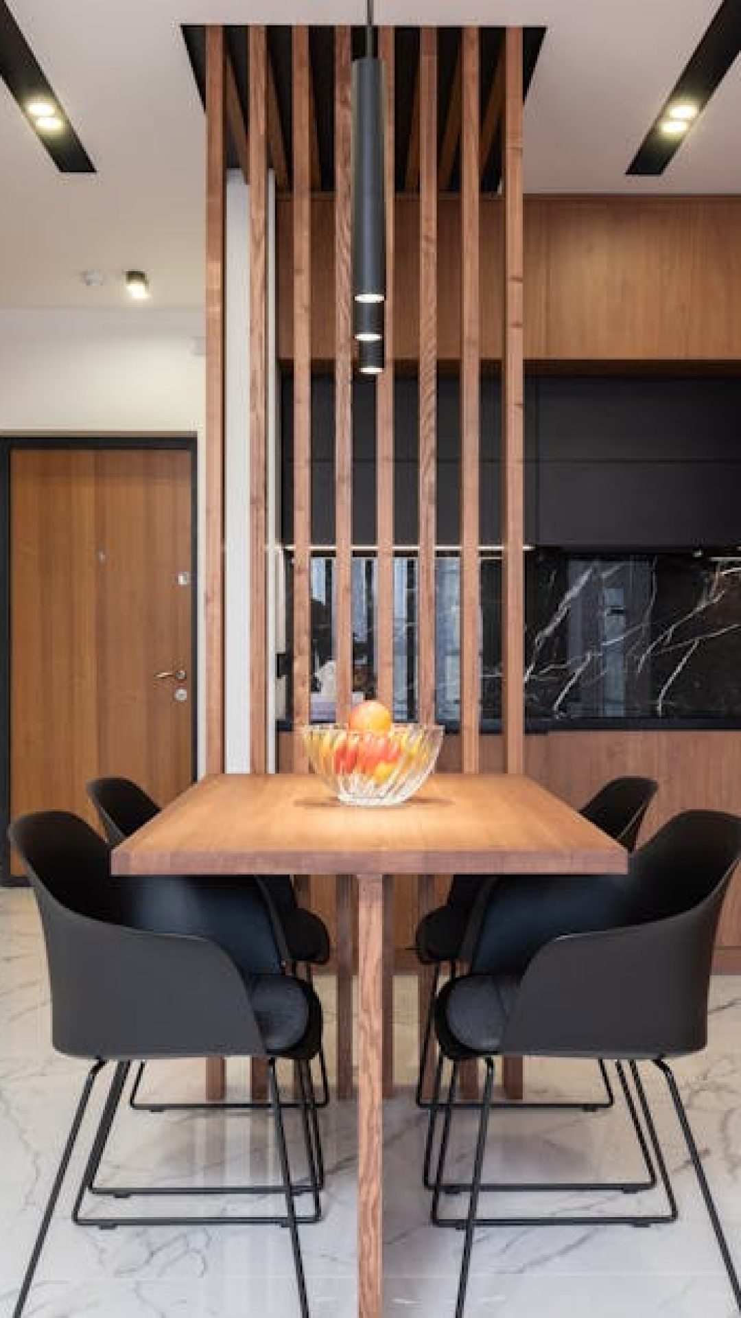 Spacious and stylish kitchen interior with wooden cabinets and dining area.